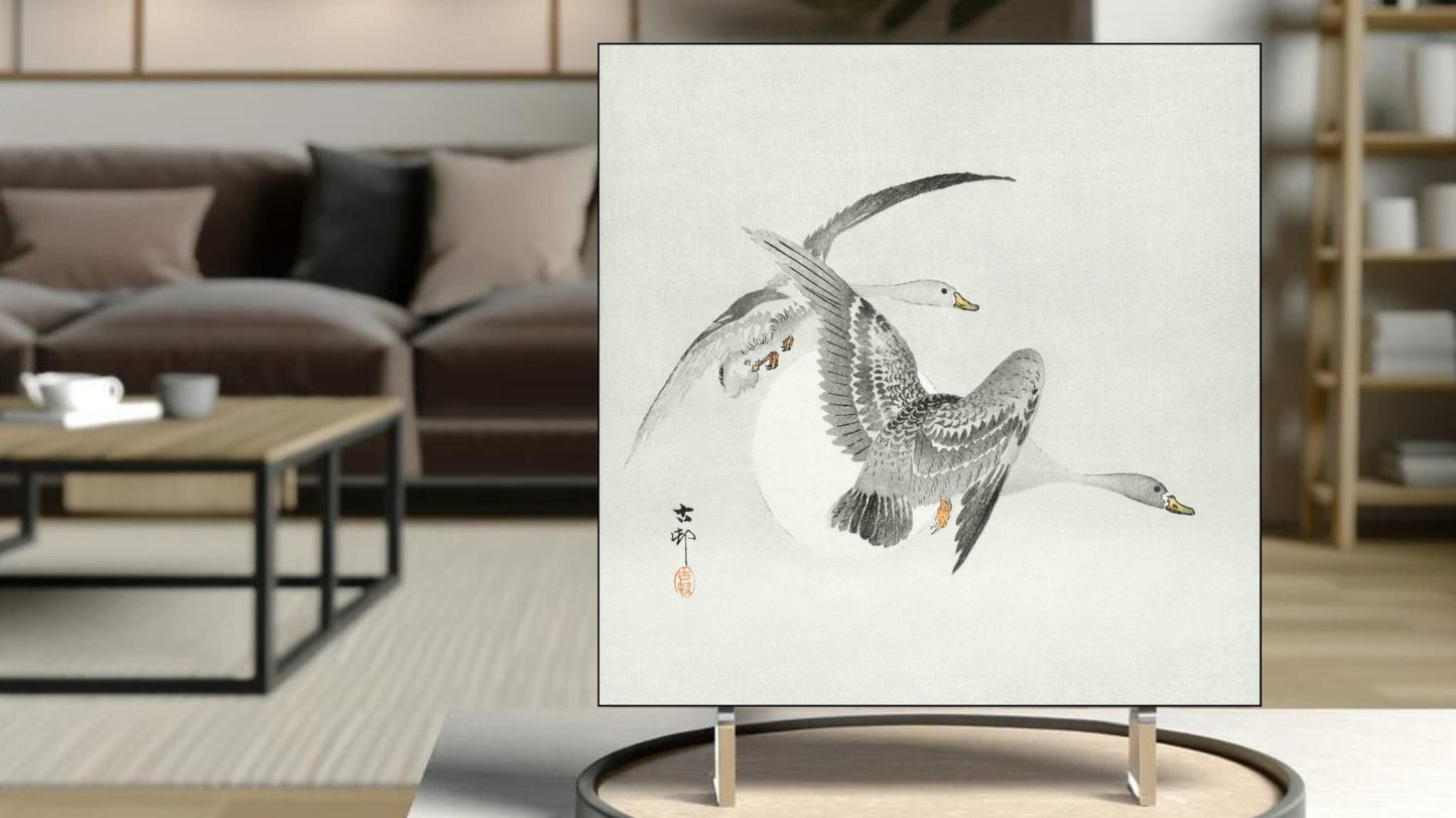 The 'Two Geese in Flight' Ukiyo-e art tile presented on a display stand as a piece of freestanding home decor.
